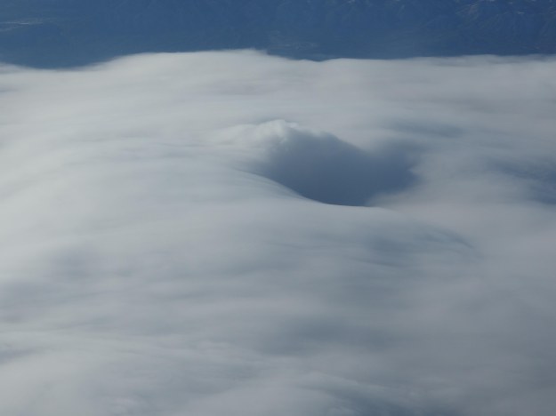 {Image: photograph of clouds taken from airplane.}