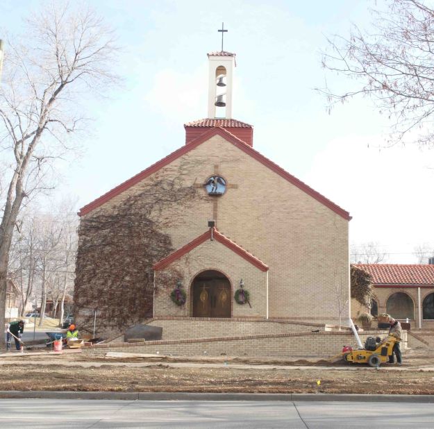 {Image:  more distant photo in which the entire church building is visible within the frame, as is the ramp extending the width of the building.  Construction equipment is visible in the lower right of the photo.}