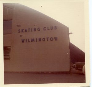 Image:  The side of a building, painted white, with large letters spelling out "Skating Club of Wilmington."