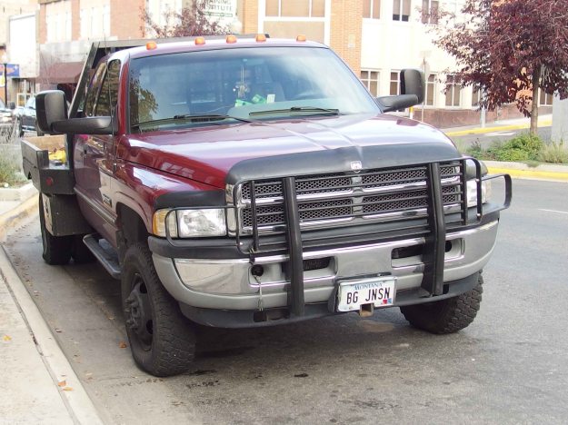 Photo of large red pickup truck with the license plate "BG JNSN." 