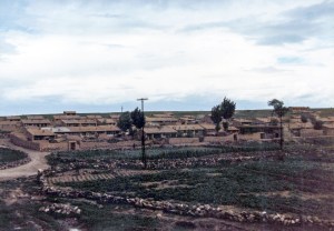 Village of low adobe-colored houses.  