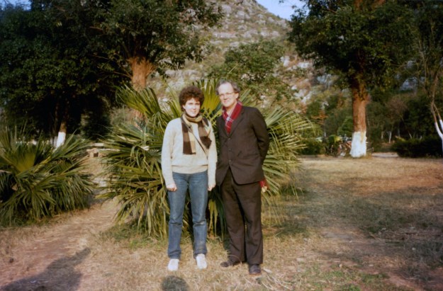 Amy and Peter posing in front of a tree.